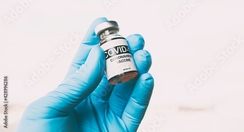 The nurse holding the covid 19 vaccine in hand