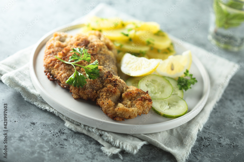 Traditional Austrian schnitzel with potato salad Traditional Austrian schnitzel with potato salad