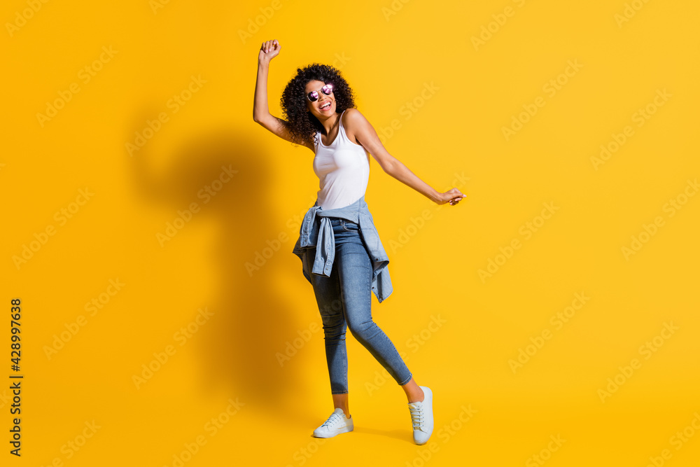Full body photo of afro american woman dance wear tight waist jacket sunglass isolated on funky yellow color background Full body photo of afro american woman dance wear tight waist jacket sunglass isolated on funky yellow color background