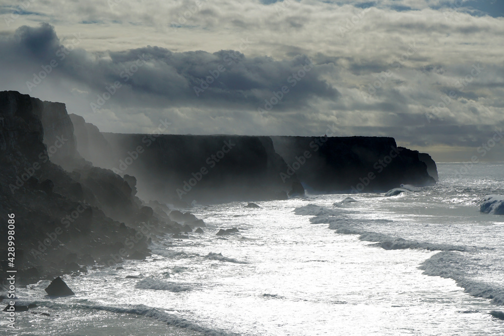 waves rolling against cliffs at Portugals Wild West coast during winter storm
waves rolling against cliffs at Portugals Wild West coast during winter storm