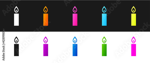 Set Burning candle icon isolated on black and white background. Cylindrical candle stick with burning flame. Vector