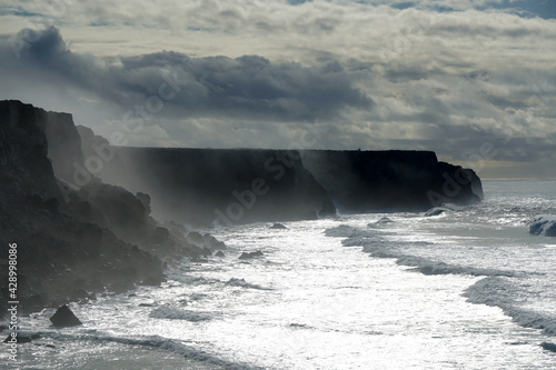 waves rolling against cliffs at Portugals Wild West coast during winter storm

