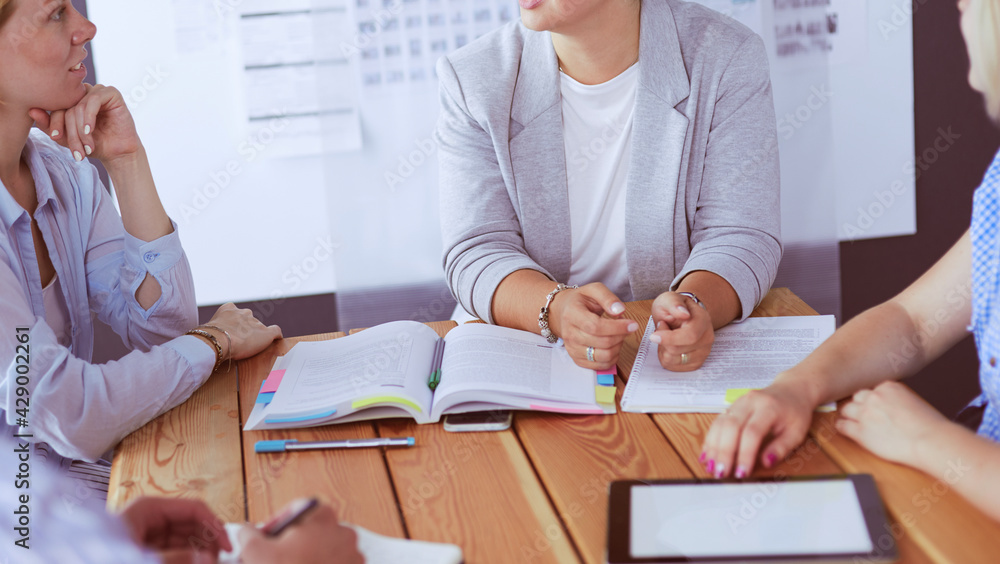 Young people studying with books on desk. Beautiful women and men working together. Young people studying with books on desk. Beautiful women and men working together.