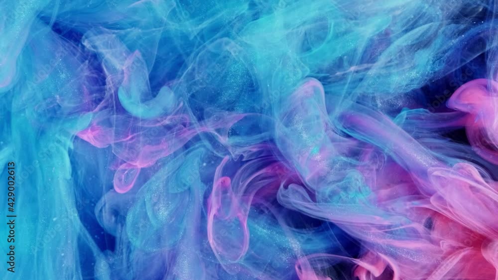 Cloud of silky ink in water isolated on black background. Colorful ink in water, ink drop. Purple, blue, pink. Cloud of silky ink in water isolated on black background. Colorful ink in water, ink drop. Purple, blue, pink.