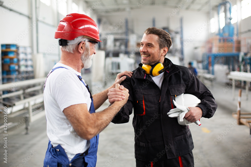 Portrait of workers in factory. Successful team working on the project