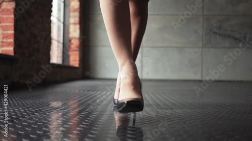 Unrecognizable Beautiful Business Woman Legs in high heels walking around the office. Slow motion. High quality FullHD footage photo