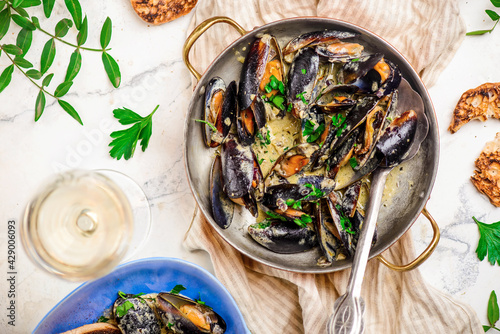 mussels in creamy sauce in a  frying pan.top view