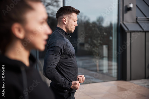 Concentrated male using breathing method during martial arts lesson