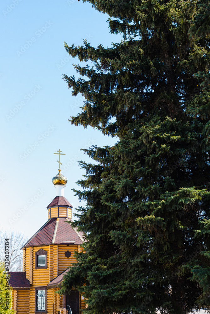 wooden temple, a temple made of logs, an Orthodox church, a Christian church, a dome of a church 
