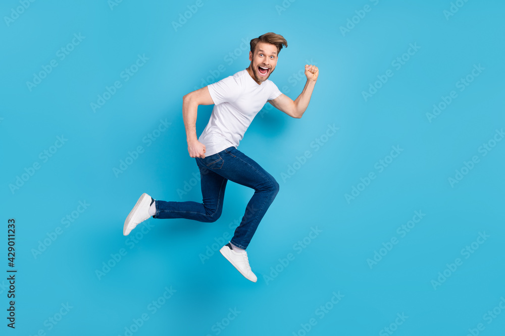 Full size profile portrait of excited cheerful guy open mouth look camera isolated on blue color background