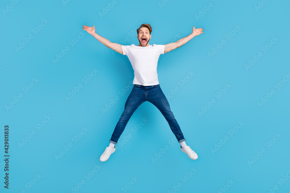 Full body portrait of astonished young guy open mouth make star figure isolated on blue color background