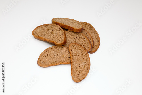 pieces of gray rye unleavened healthy bread on a white background