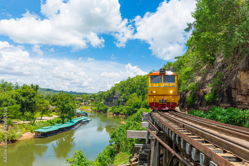 Naklejka premium trains running on death railways track crossing kwai river in kanchanaburi thailand this railways important destination of world war II history builted by soldier prisoners