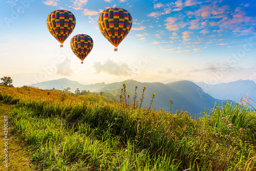 Hot air balloons and mountains and beautiful sky,Colorful hot-air balloons flying over the mountain and sea of mist, Doi Inthanon Natural Park Chiang Mai, Thailand