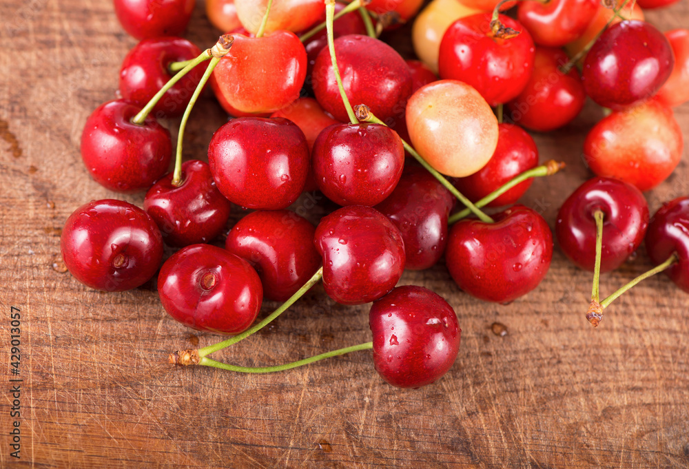 Cherries on wooden table with water drops Cherries on wooden table with water drops