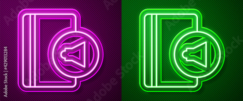 Glowing neon line Audio book icon isolated on purple and green background. Book with headphones. Audio guide sign. Online learning concept. Vector