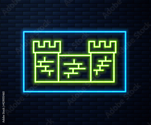 Glowing neon line Great wall of China icon isolated on brick wall background. Vector