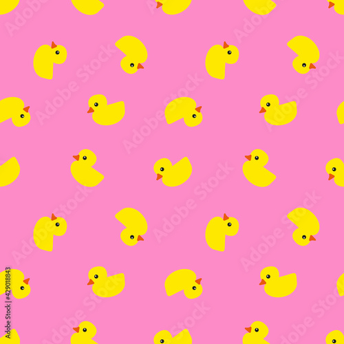 Yellow rubber ducks with orange beaks and black eyes on pink background, seamless pattern 