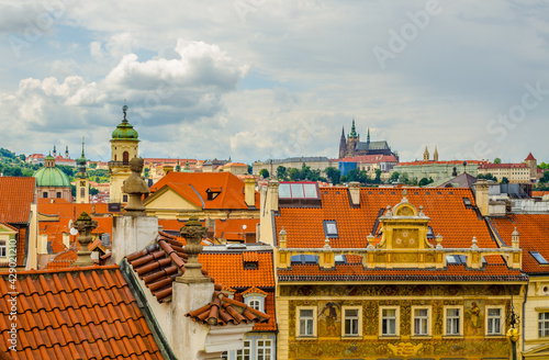 aerial view of prague castle hidden behind red-tile rofftops. photo