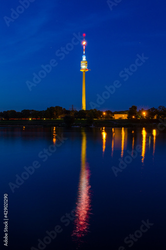 Photography Donauturm in Vienna reflecting on danube river during night