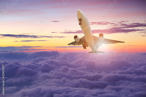 Big white airplane is flying sky at sunset for Business trip with Commercial plane, Transportation, import-export and logistics, Travel concept 