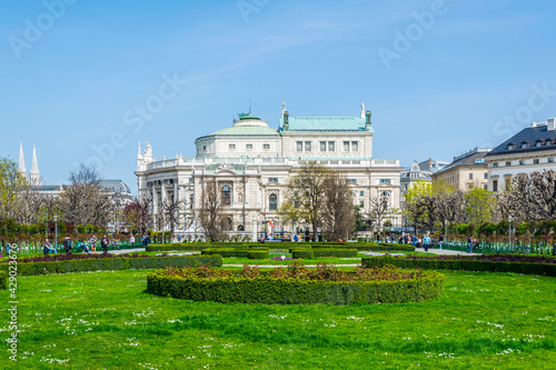 Beautiful view of famous Volksgarten (People's Garden) public park with historic Burgtheater in the background in Vienna, Austria. photo