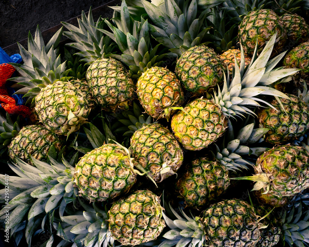 large batch of sweet and ripe pineapples for sale in public market large batch of sweet and ripe pineapples for sale in public market
