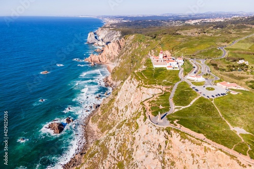 Obraz na płótnie Aerial view of Cabo da Roca lighthouse with majestic coastline looking the Atlantic Ocean, a famous landmark in Colares, Lisbon, Portugal. w salonie