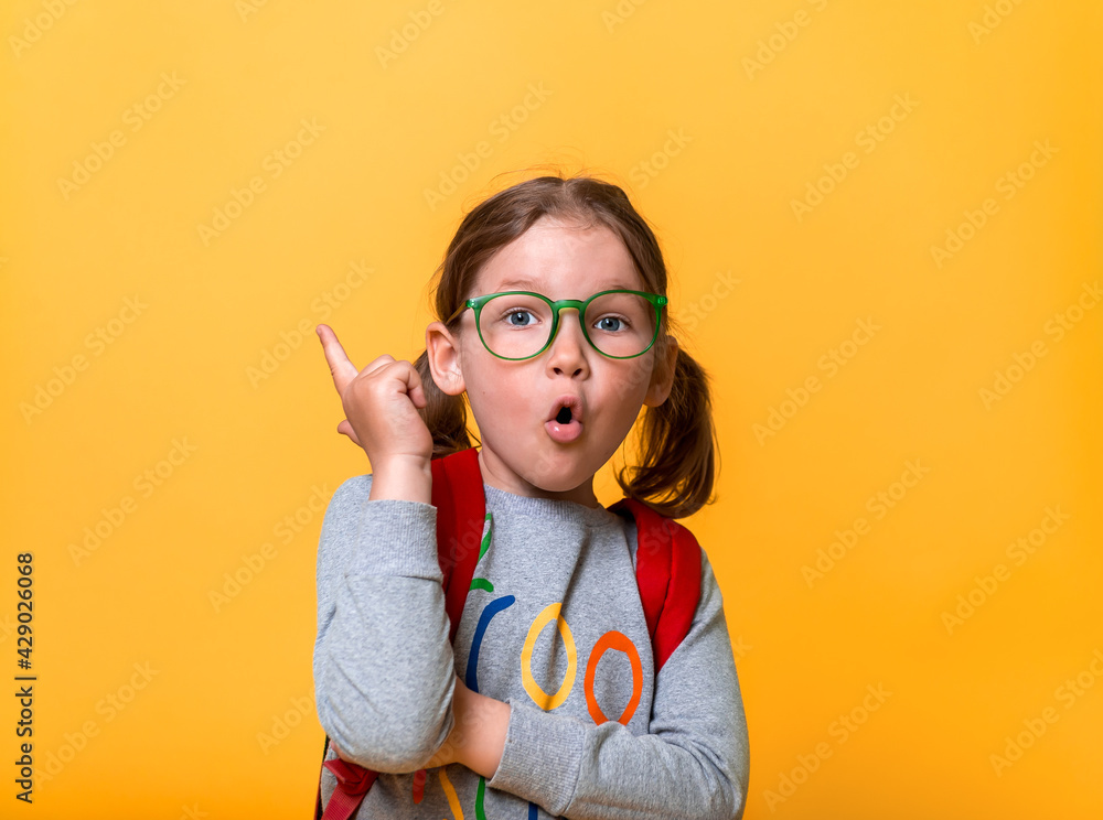 Little girl has and idea. Back to school. Kid pointing finger up. Nerd child in glasses. Pupil expert. News and innovation in education Little girl has and idea. Back to school. Kid pointing finger up. Nerd child in glasses. Pupil expert. News and innovation in education