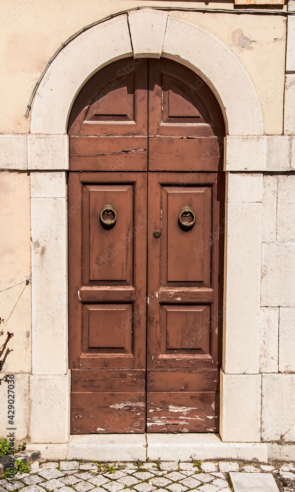 Old wooden italian door in a small village in Abruzzo Old wooden italian door in a small village in Abruzzo