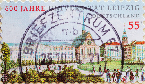 GERMANY - CIRCA 2009 : a postage stamp from Germany, showing some historical buildings with people in front of Leipzig University. 600 years