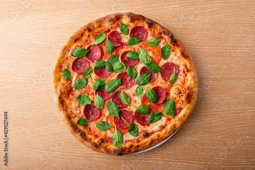 Pepperoni pizza with fresh basil leaf