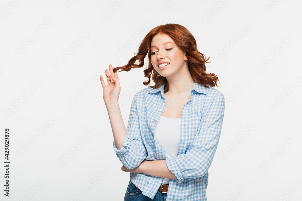 positive young woman in blue checkered shirt adjusting hair isolated on white. positive young woman in blue checkered shirt adjusting hair isolated on white.