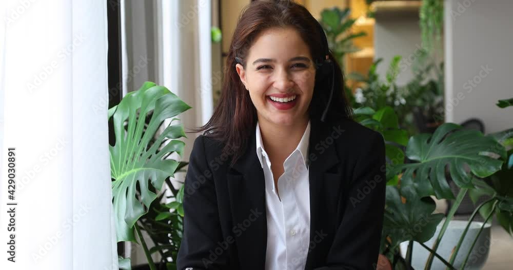Attractive business woman Asian in suits and headsets are smiling while working with computer at office. Customer service assistant working in office. VOIP Helpdesk headset Attractive business woman Asian in suits and headsets are smiling while working with computer at office. Customer service assistant working in office. VOIP Helpdesk headset