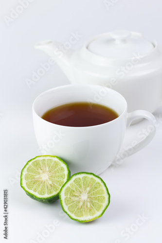 Canvas Print Bergamot tea or Earl Grey tea in white cup and fresh bergamot fruit with sliced isolated on white background