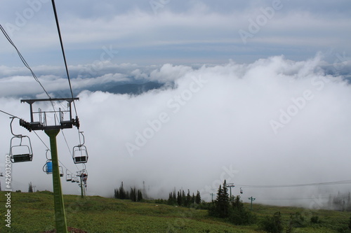 Chairlift in bad weather in Sheregesh in summer in fog