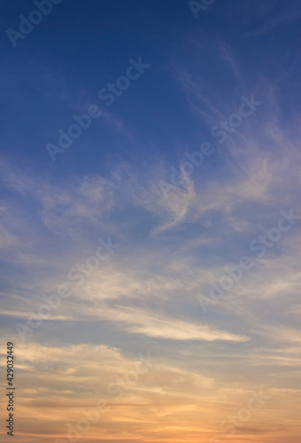 Fototapeta Naklejka Na Ścianę i Meble -  sunset sky and clouds vertical with colorful orange sunlight 