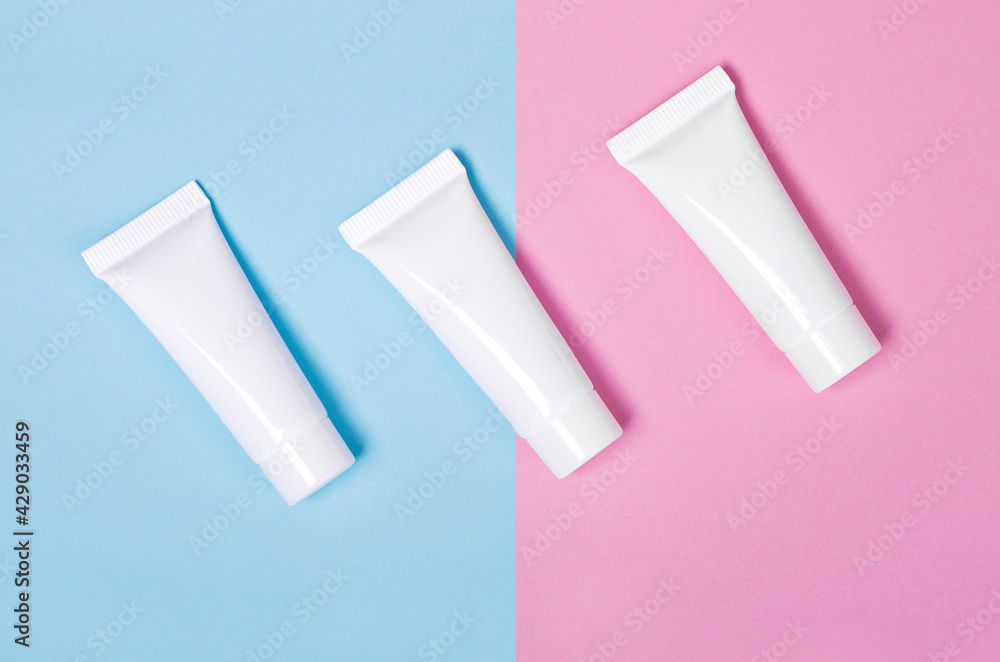 Cream tube mock up isolated on pink and blue background set of three white blank cream jars Cream tube mock up isolated on pink and blue background set of three white blank cream jars