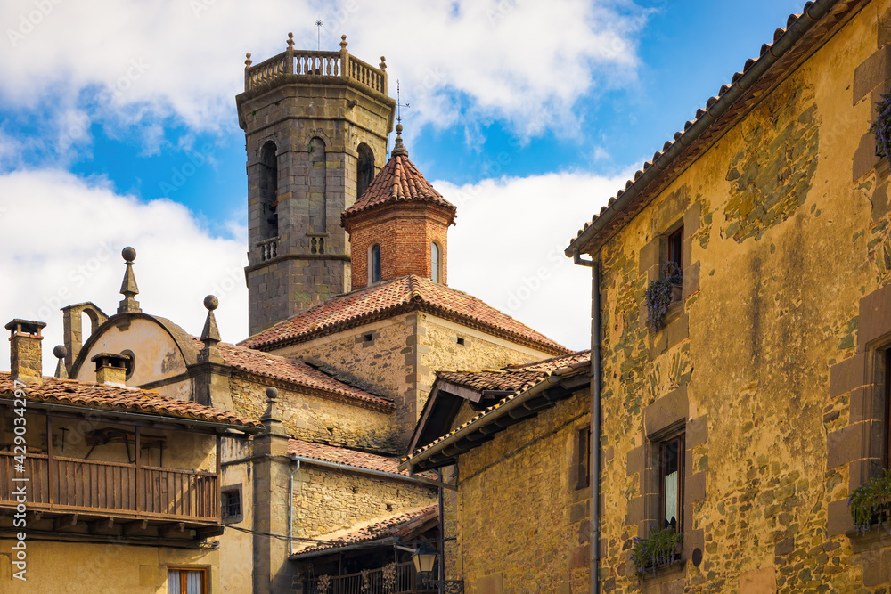 View of the bell tower and the dome of the Saint Miquel church of the medieval nucleus of the town of Rupit, Catalonia, Spain