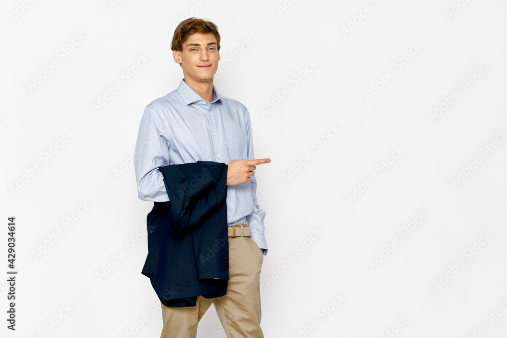 business man in a suit with a jacket on his arm model light background