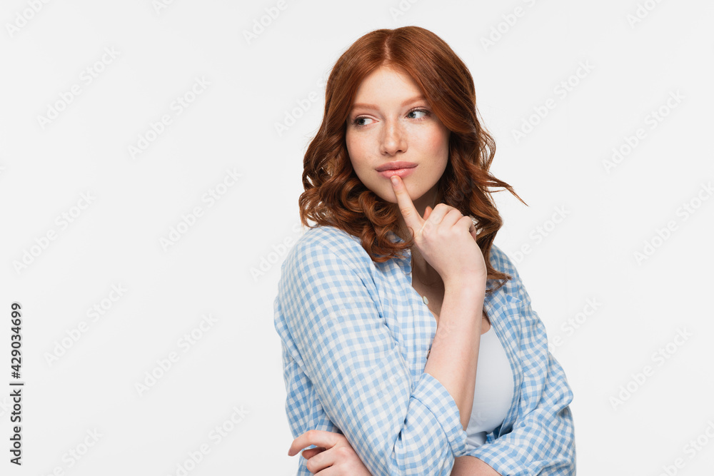 pensive redhead young woman in blue checkered shirt looking away isolated on white. pensive redhead young woman in blue checkered shirt looking away isolated on white.