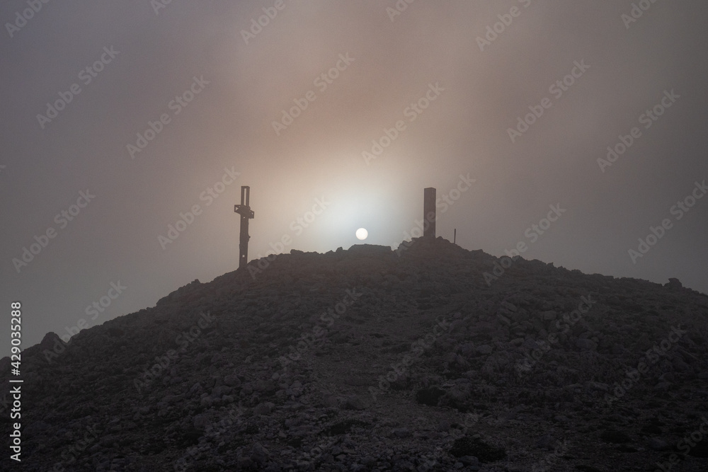 peak of Monte Amaro at sunset immersed in the fog in the Majella national park, mountain range of the Apennines. Maiella mountain massif, Abruzzo, L'Aquila.