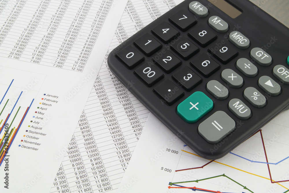 Black calculator on financial documents close up. Concept of business, calculating and accounting. Black calculator on financial documents close up. Concept of business, calculating and accounting.