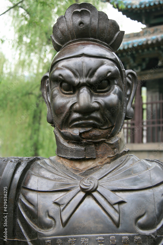 statue of a guardian (?) in the jinci monastery in taiyuan in china 