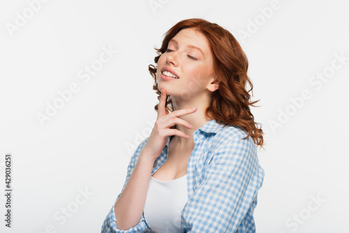 happy redhead young woman with closed eyes isolated on white.
