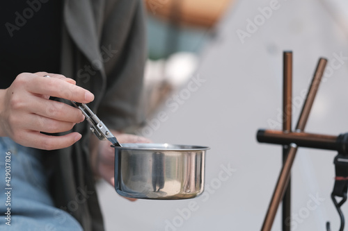 A woman eating something during camping.