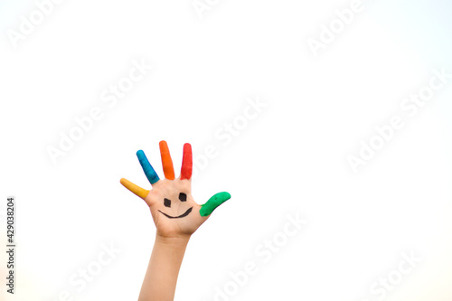 Wallpaper Mural Children hand in colorful paint with funny smile face isolated on white background Torontodigital.ca