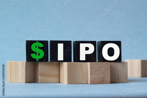 wooden blocks with the word IPO on blue background. Business strategy, business management or business success concept.