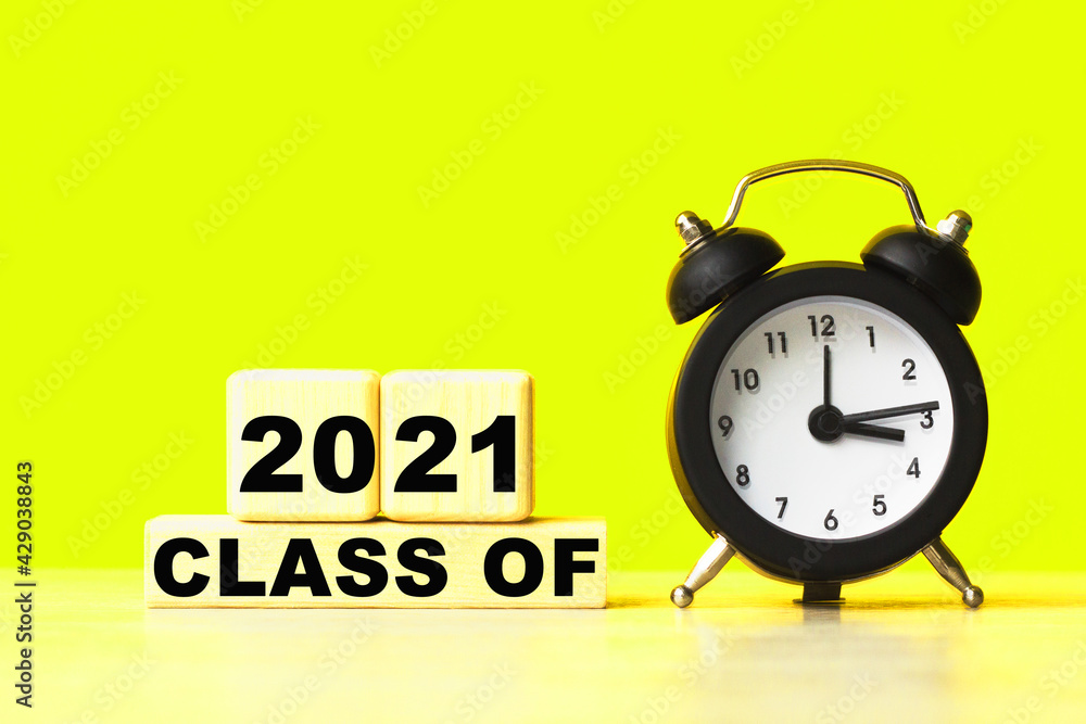 A word CLASS OF 2021 on black notebook with clock. Concept for time management and business. A word CLASS OF 2021 on black notebook with clock. Concept for time management and business.