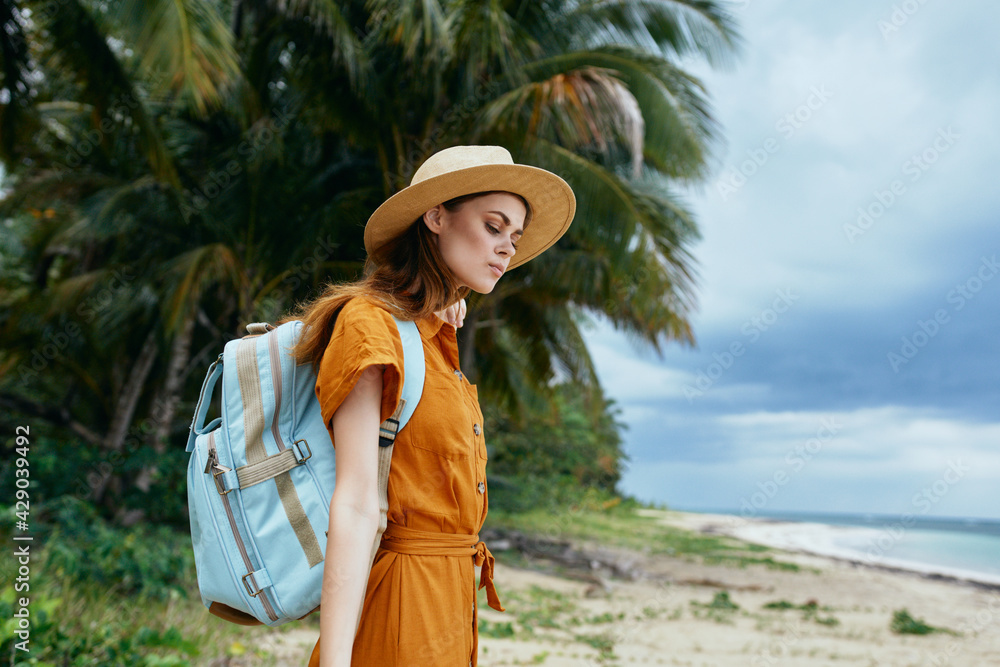 woman with backpack in nature near the sea on the island travel tourism model